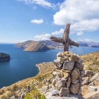 Cross On A Hill With Lake Titicaca In The Background Taken From Isla Del Sol In Bolivia